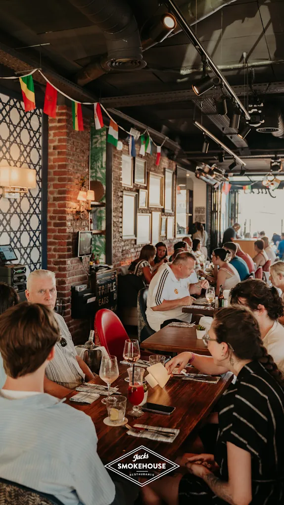 A busy evening inside Jack's Benalmádena with bunting, brick walls and full tables