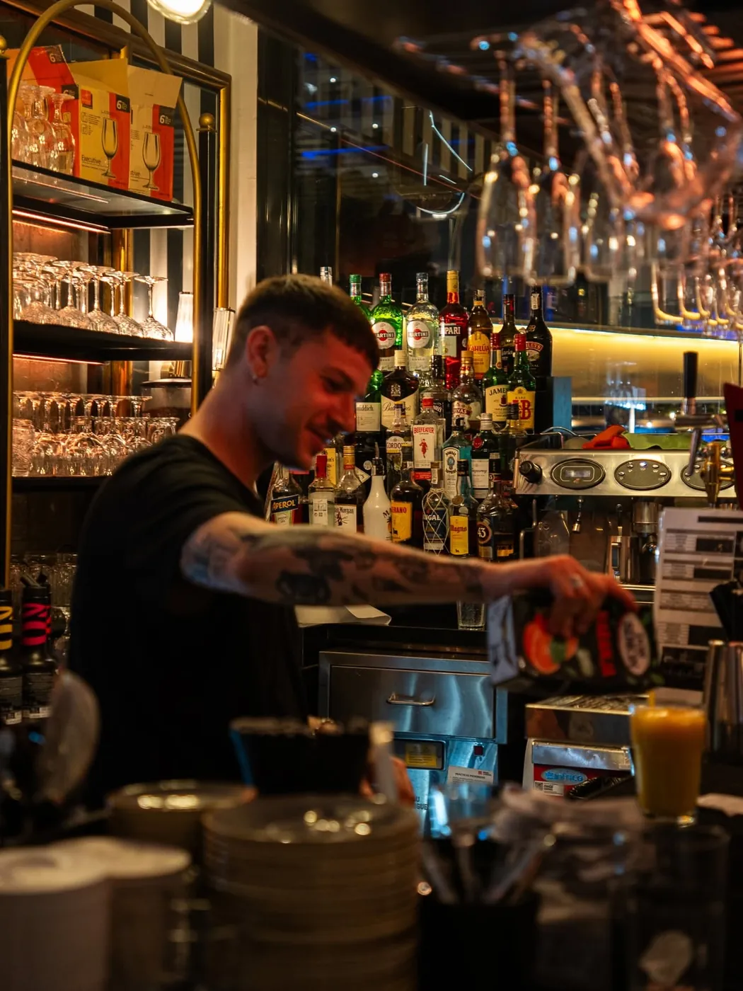 A bartender making drinks behind the back bar at Jack's Benalmádena